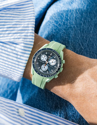Mint rubber strap for OMEGA x Swatch MoonSwatch Mission On Earth, worn on the wrist in a lifestyle photo