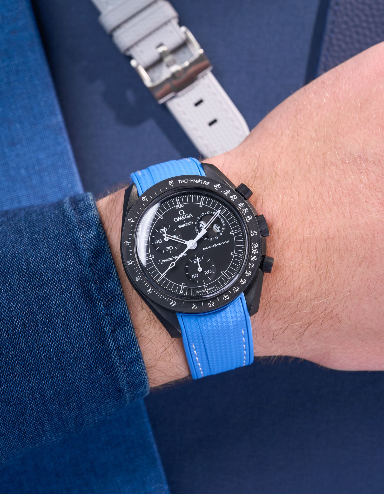 MoonSwatch Mission to Moonphase New Moon on the wrist with vertech neptune blue rubber strap styled with blue shirt