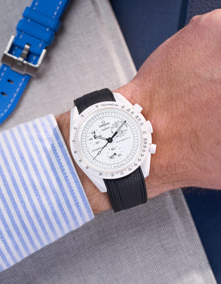 MoonSwatch Mission to the Moonphase with black rubber strap wrist shot styled with striped shirt