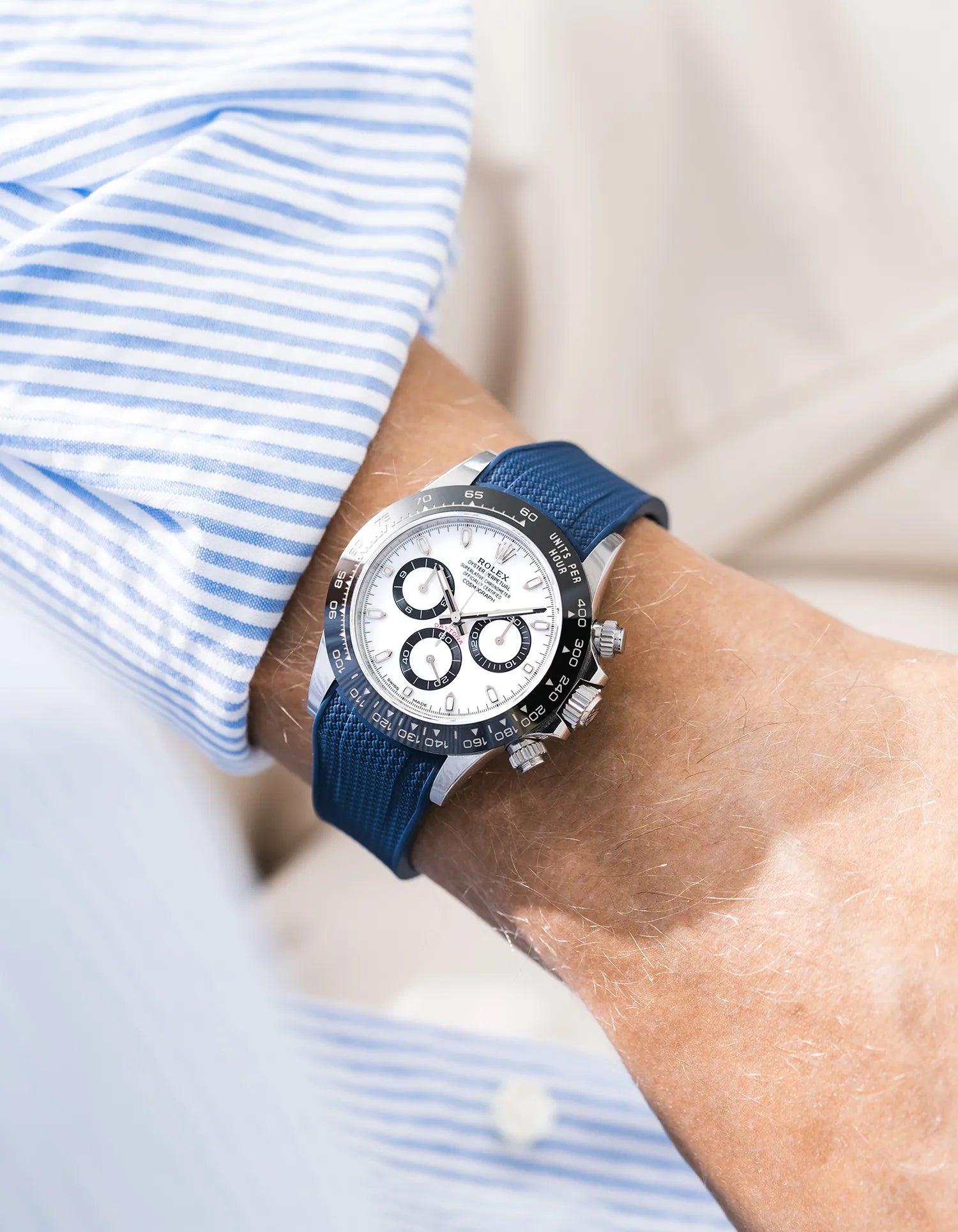 Vertech navy blue integrated FKM rubber strap with original clasp on Rolex Daytona 116500 white dial ceramic bezel wrist shot with blue and white shirt