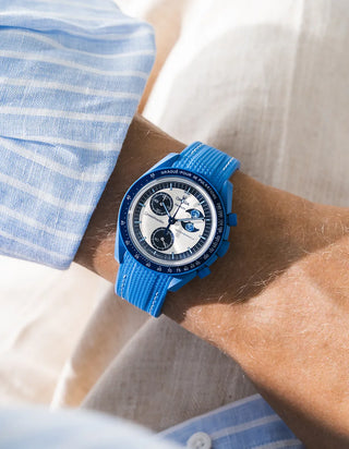 Neptune Blue rubber strap for OMEGA x Swatch MoonSwatch Mission to the Super Blue Moonphase, worn on the wrist in a lifestyle photo