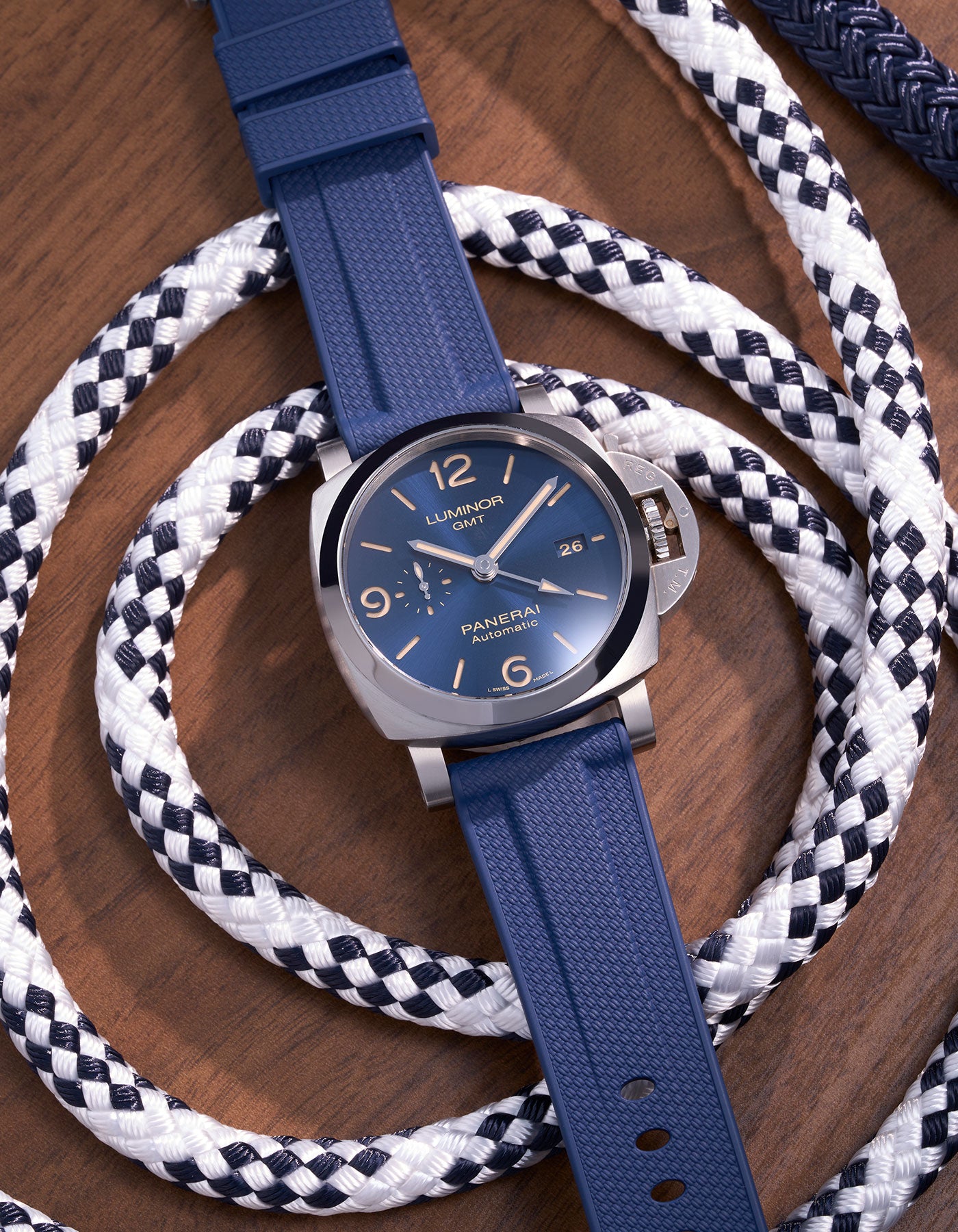 Panerai Luminor GMT Blue Dial with Navy Blue Rubber Strap on Nautical Ropes – Swiss Made luxury watch with iconic Italian design, 44mm polished stainless steel case paired with premium 24mm navy blue rubber uhrenband klockarmband, ideal for maritime and outdoor environments. Perfect for Panerai enthusiasts who value both durability and style, this automatic GMT model combines functionality and elegance, making it suitable for both diving adventures and formal occasions. Panerai klockarmband replacement stra