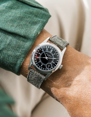 Patek Calatrava on a green denim leather watch strap from Wristbuddys on a persons wrist wearing a green shirt