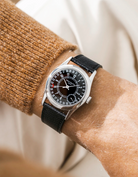 Patek Calatracva on a black epsom leather strap from Wristbuddys on a persons wrist with a beige/brown shirt