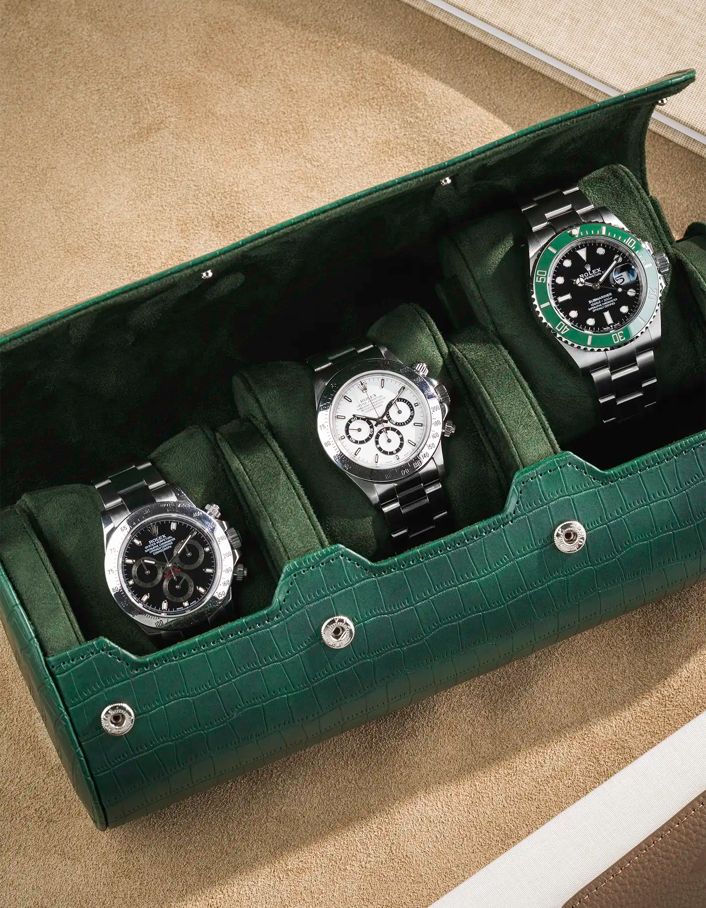 Close up on Green embossed alligator 3 Slot Watch Roll with beige background