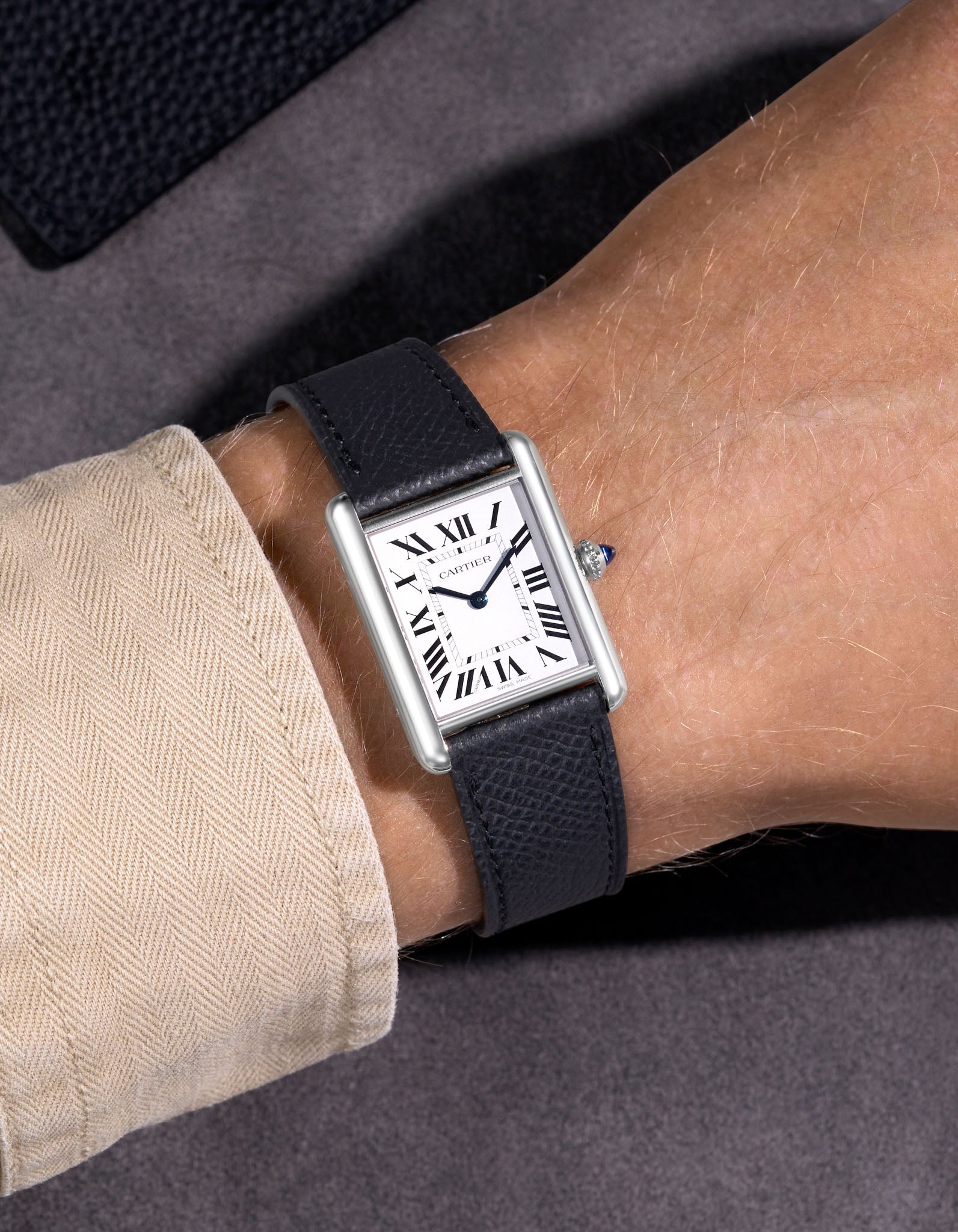 Cartier Santos on a black epsom leather watch strap on a wrist.