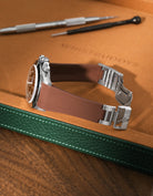 Brown Vertech FKM rubber watch band for Rolex Daytona 16520, custom integrated fit with original clasp, resting on a brown leather valet tray.