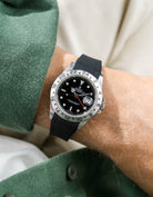 Close-up of a person wearing a Rolex Explorer 2 16570 model watch with a green jacket sleeve and a black FKM rubber watch strap from Wristbuddys
