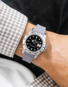 Close-up of a person wearing a Rolex Explorer 2 16570 model watch with a white beige jacket sleeve and a grey FKM rubber watch strap from Wristbuddys