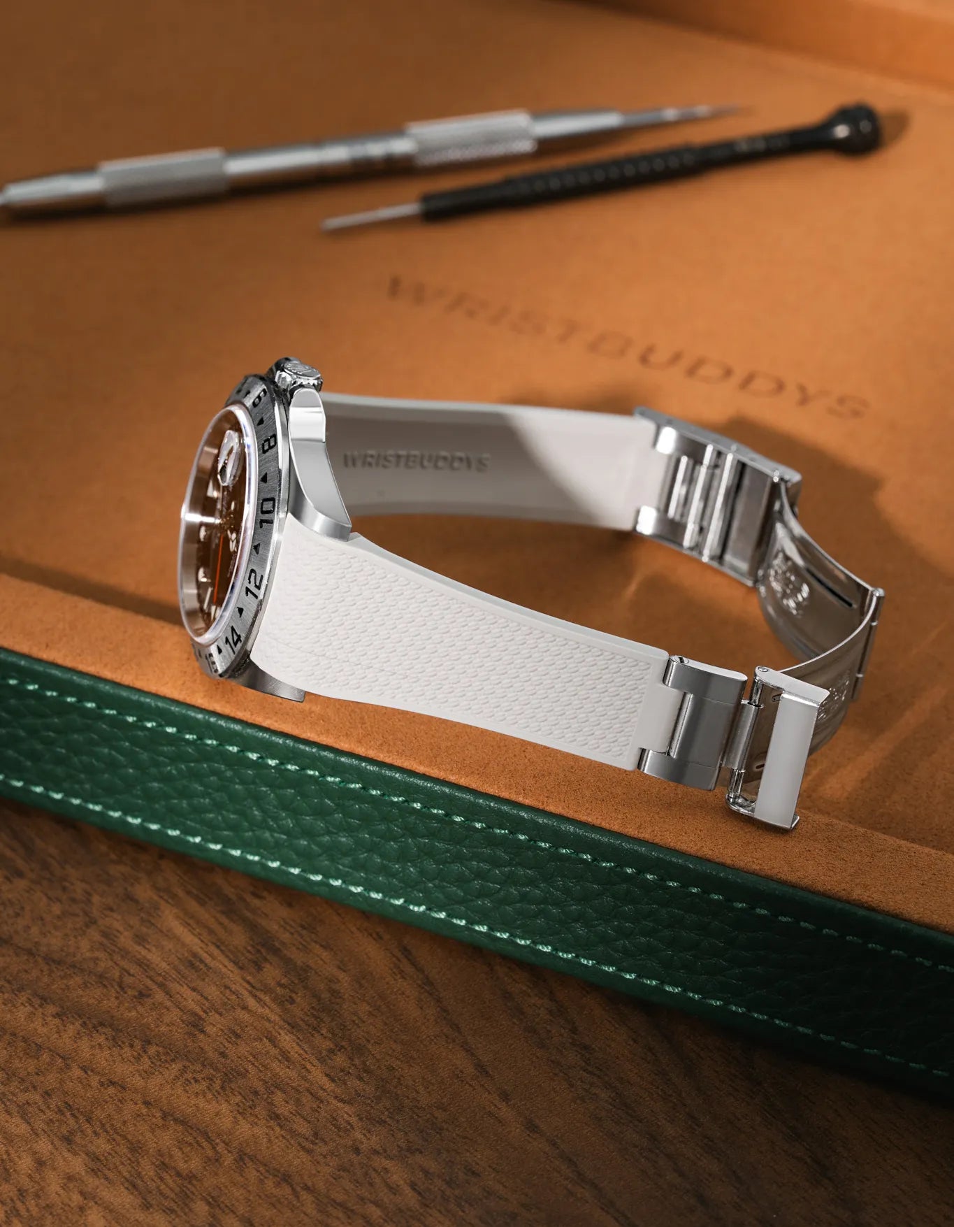 Beige Vertech FKM rubber strap for Rolex Explorer II 16570, integrated seamless fit with original clasp, resting on a leather watch tray.