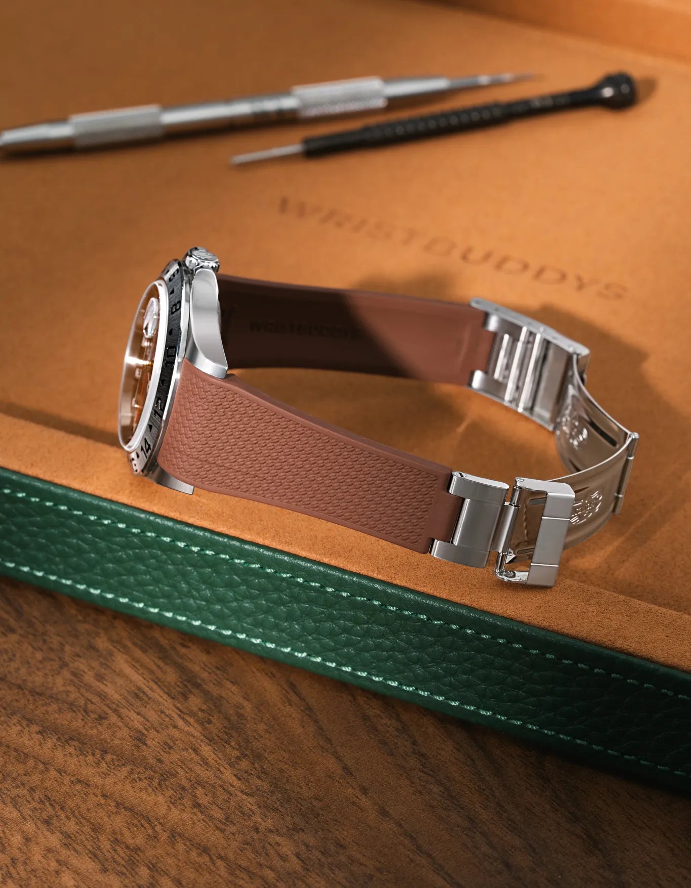 Brown Vertech-surface FKM rubber strap for Rolex Explorer II 16570, premium integrated design for original clasp, resting on a brown leather tray.