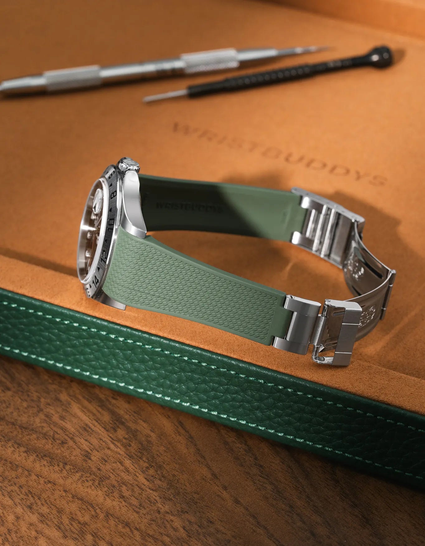 Military Green FKM rubber strap for Rolex Explorer II 16570, integrated case fit for original clasp, resting on a leather watch tray with tools.