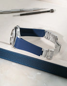 Navy Blue Vertech FKM rubber strap for Rolex Explorer II 16570, seamless integration with original clasp, resting on a blue leather valet tray.