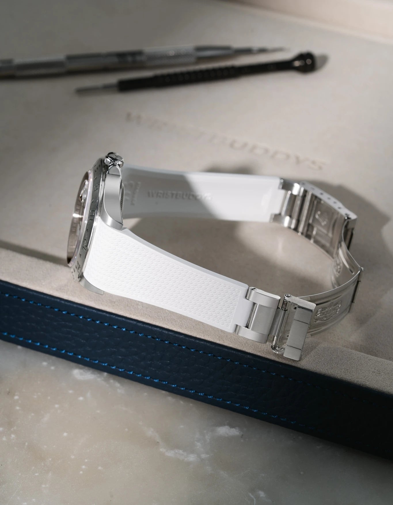 White textured FKM rubber watch band for Rolex Explorer II 16570, premium custom integrated fit for original clasp, shown on a white valet tray.