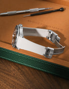 Beige Vertech FKM rubber strap for Rolex GMT-Master II 116710, integrated seamless fit with original clasp, resting on a leather valet tray.