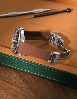 Brown textured FKM rubber watch band for Rolex GMT-Master II 116710, premium integrated design for original clasp, shown on a brown leather tray.