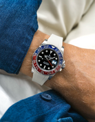 Close-up of a person wearing a Rolex GMT Master 2 Pepsi model watch with a blue jacket sleeve and a beige FKM rubber watch strap from Wristbuddys