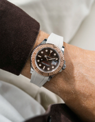 Close-up of a person wearing a Rolex YachtMaster 2 126622 / 116622 model watch with a brown shirt sleeve and a beige FKM rubber watch strap from Wristbuddys