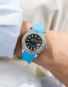 Close-up of a person wearing a Rolex YachtMaster 2 126622 / 116622 model watch with a light blue shirt sleeve and a capri FKM rubber watch strap from Wristbuddys