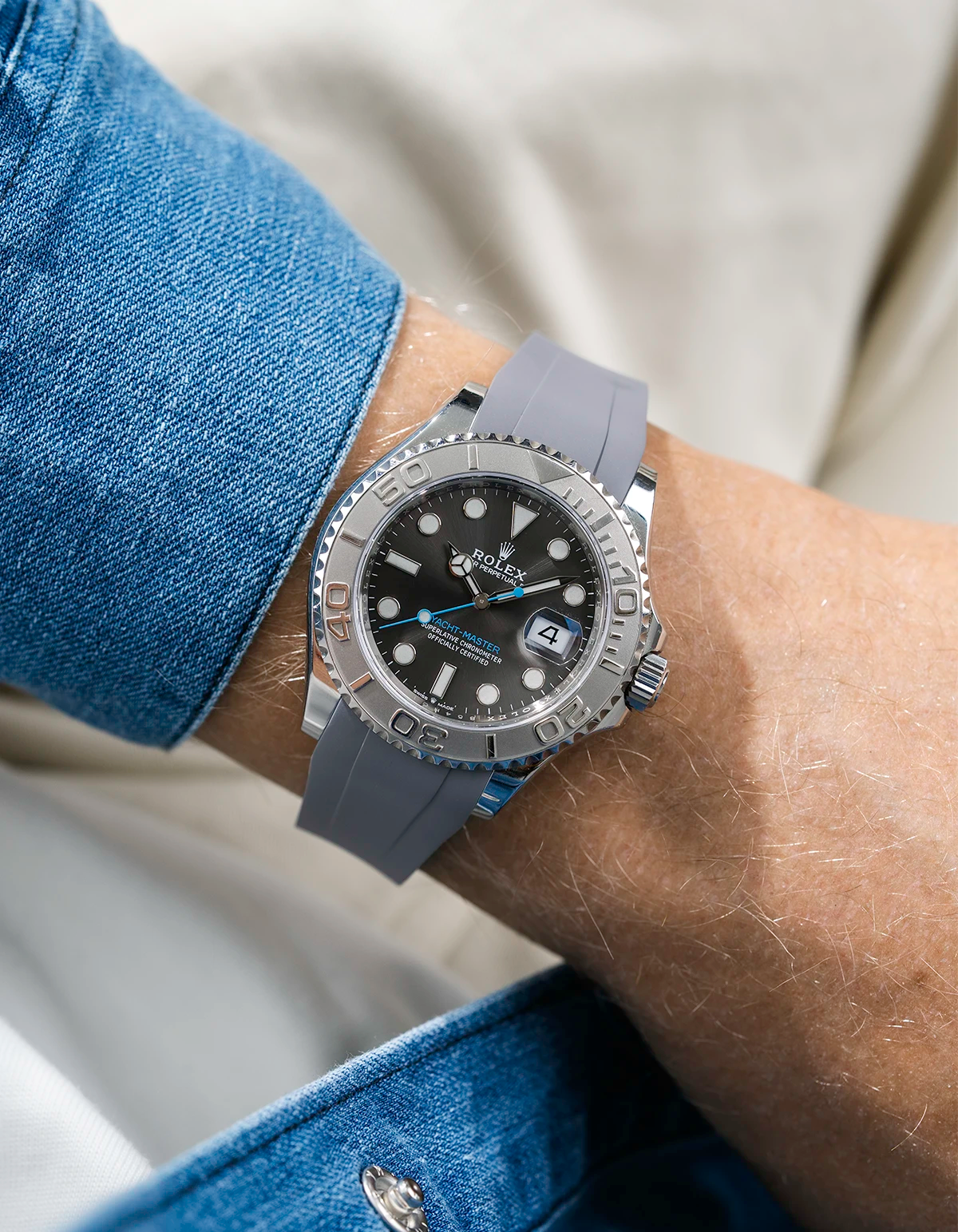 Close-up of a person wearing a Rolex YachtMaster 2 126622 / 116622 model watch with a blue shirt sleeve and a grey FKM rubber watch strap from Wristbuddys