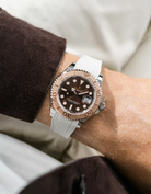 Close-up of a person wearing a Rolex YachtMaster 2 126622 / 116622 model watch with a brown shirt sleeve and a Capri beige Vertech FKM rubber watch strap from Wristbuddys