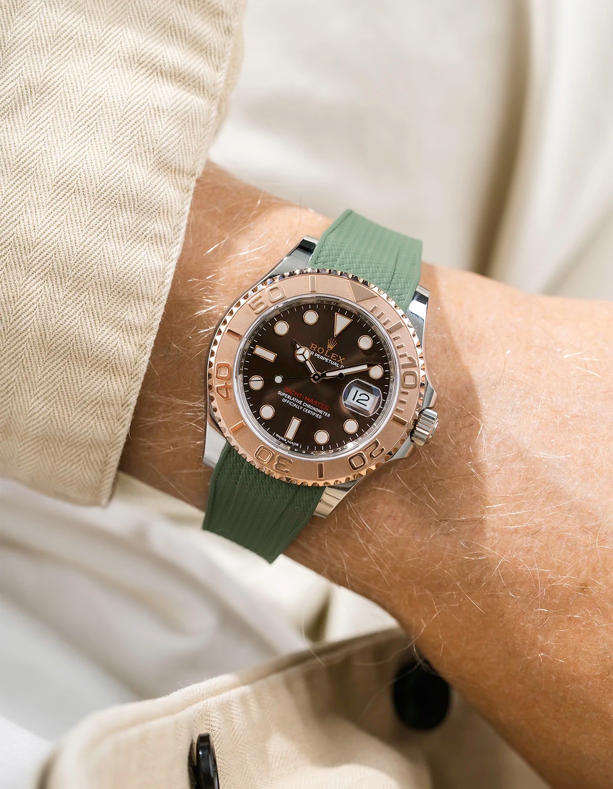 Close-up of a person wearing a Rolex YachtMaster 2 126622 / 116622 model watch with a beige shirt sleeve and a Capri green Vertech FKM rubber watch strap from Wristbuddys