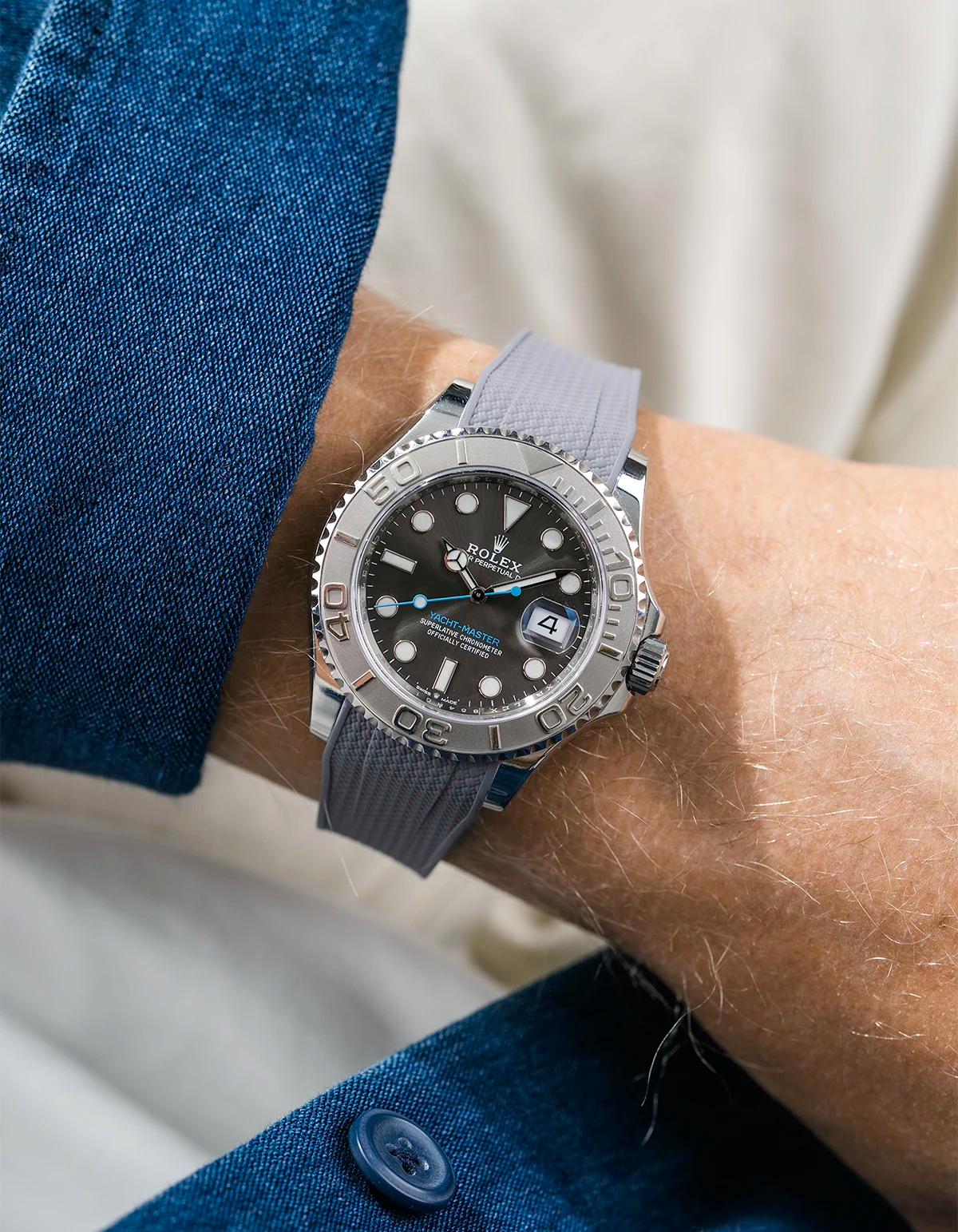 Close-up of a person wearing a Rolex YachtMaster 2 126622 / 116622 model watch with a blue shirt sleeve and a Capri grey Vertech FKM rubber watch strap from Wristbuddys