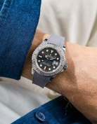 Close-up of a person wearing a Rolex YachtMaster 2 126622 / 116622 model watch with a blue shirt sleeve and a Capri grey Vertech FKM rubber watch strap from Wristbuddys