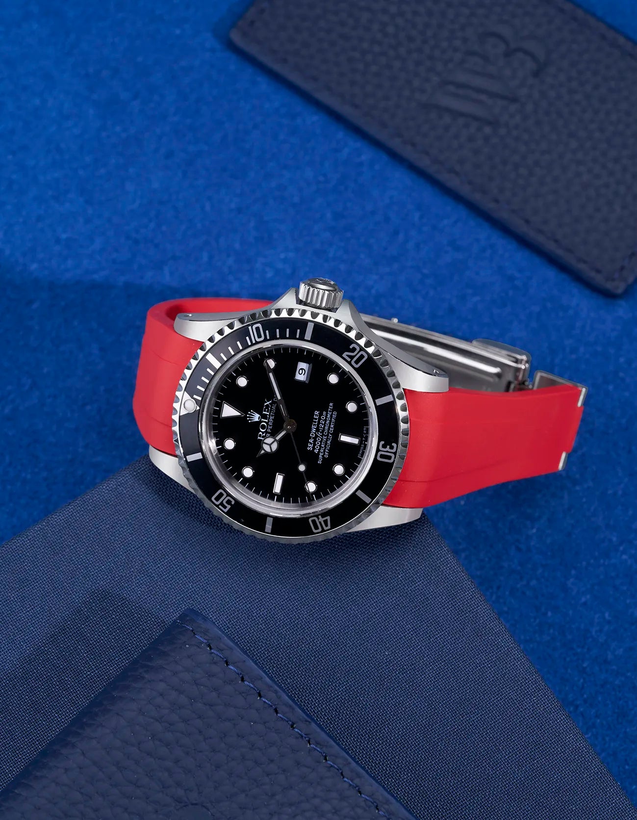 Red FKM rubber strap mounted on Rolex Sea-Dweller 16600 – integrated clasp flat lay