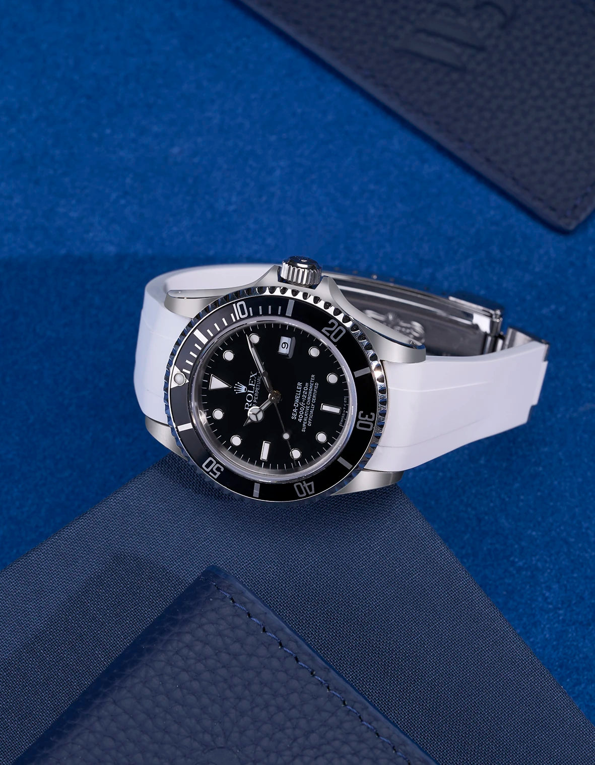 Rolex Sea-Dweller 16600 on white FKM rubber strap with integrated original clasp – styled flat composition
