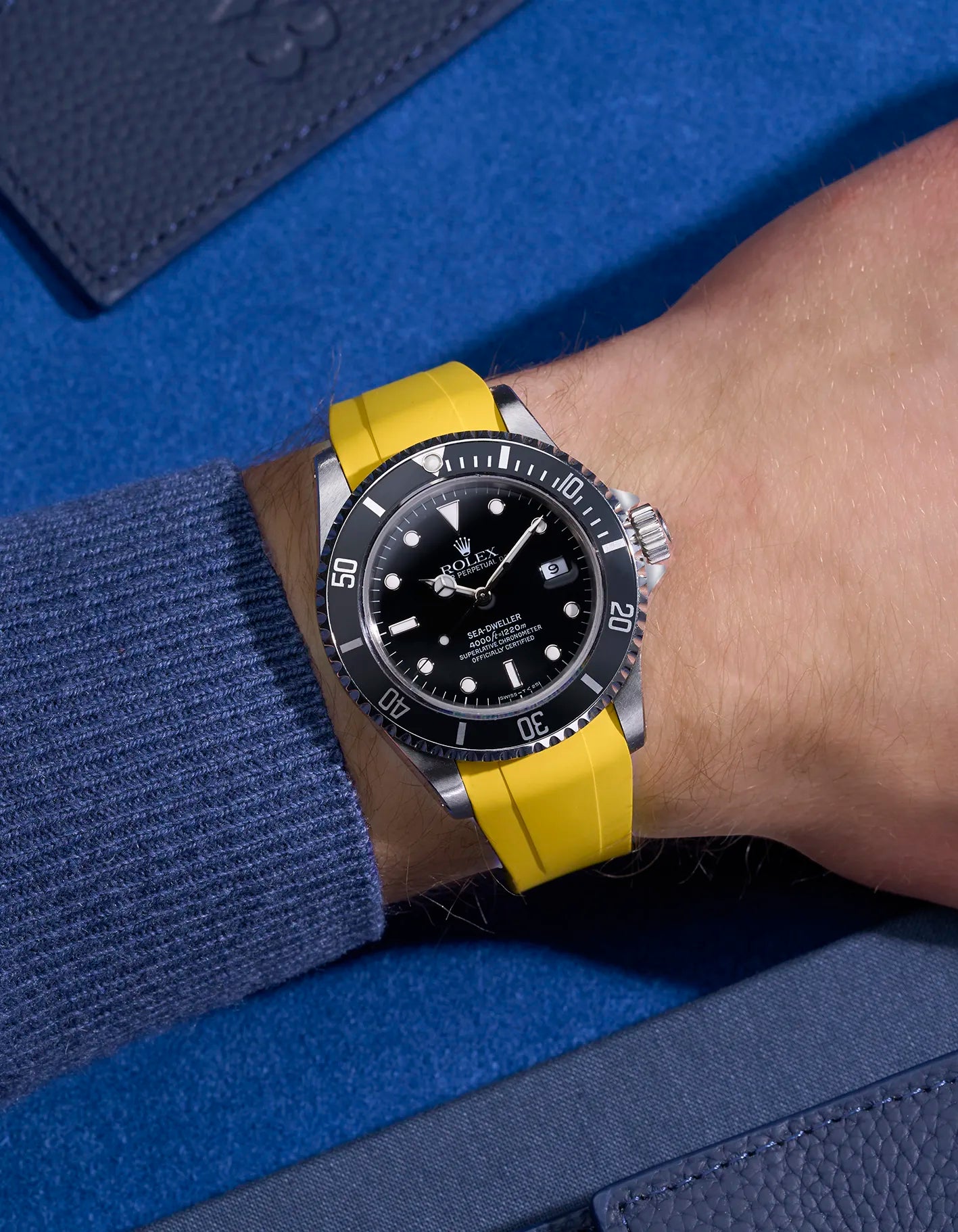 Wrist shot of Rolex Sea-Dweller 16600 on yellow FKM rubber strap with integrated original clasp