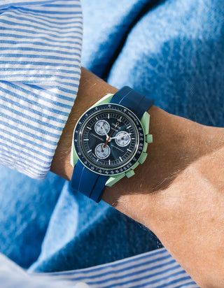 Smooth blue rubber strap for OMEGA x Swatch MoonSwatch Mission On Earth, worn on the wrist in a lifestyle photo