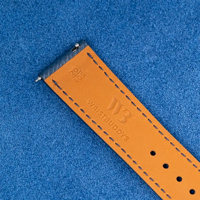 Back view of a suede leather watch strap in tan with Wristbuddys logo, detailed stitching, and a quick release spring bar for easy attachment and removal.