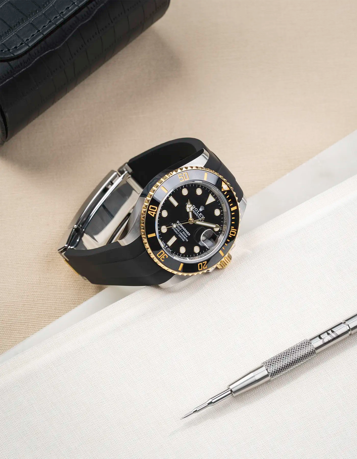 Product image of Rolex Submariner 41 with black FKM Rubber Strap fitted on the watch, integrated with original clasp – angled front shot with clasp closed