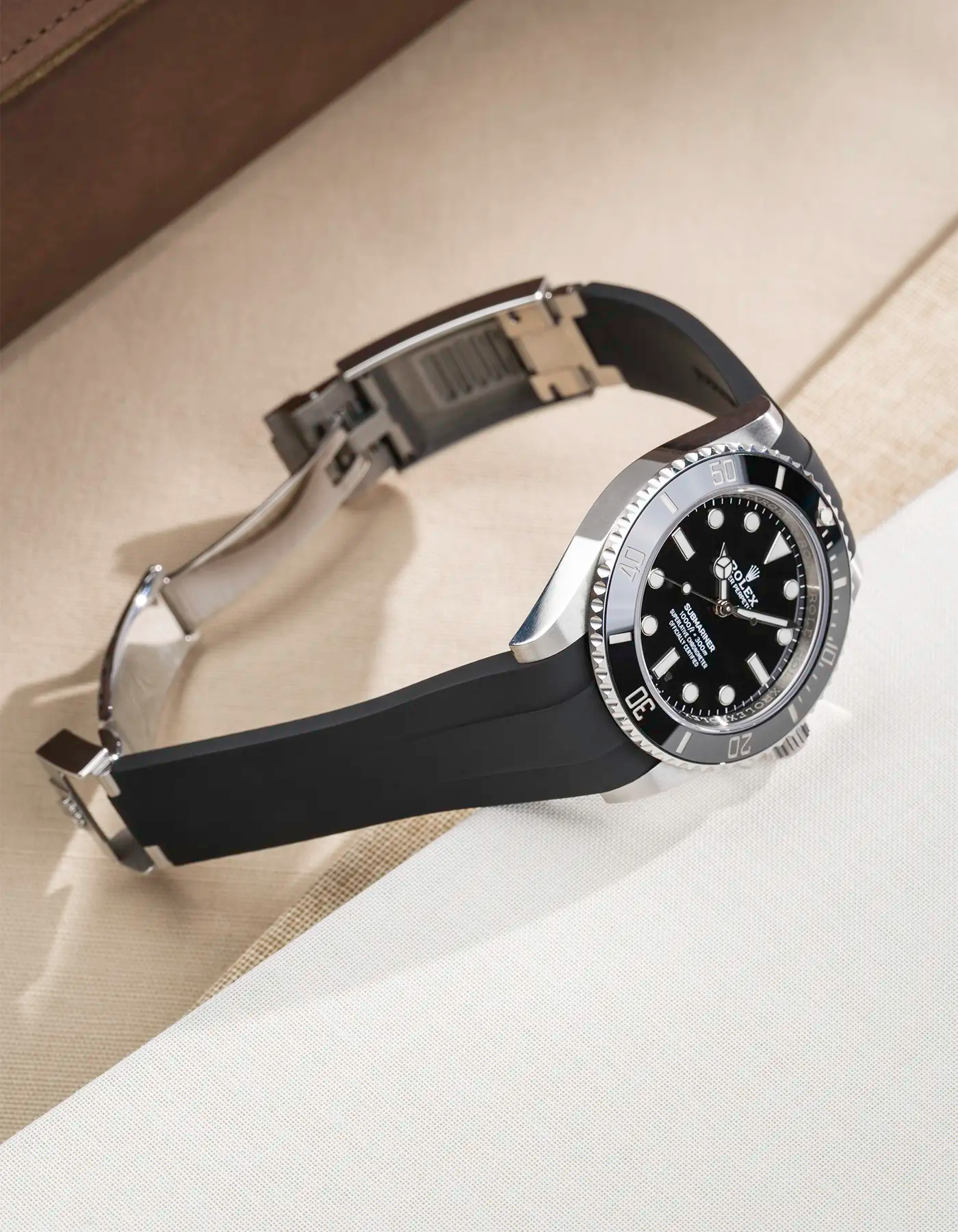 Rolex Submariner 41 with black Classic Smooth FKM Rubber Strap sitting on the watch, integrated with original clasp – product photo side angle with clasp open