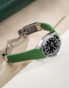 Rolex Submariner 41 with green Classic Smooth FKM Rubber Strap sitting on the watch, integrated with original clasp – lifestyle product photo side angle with clasp open