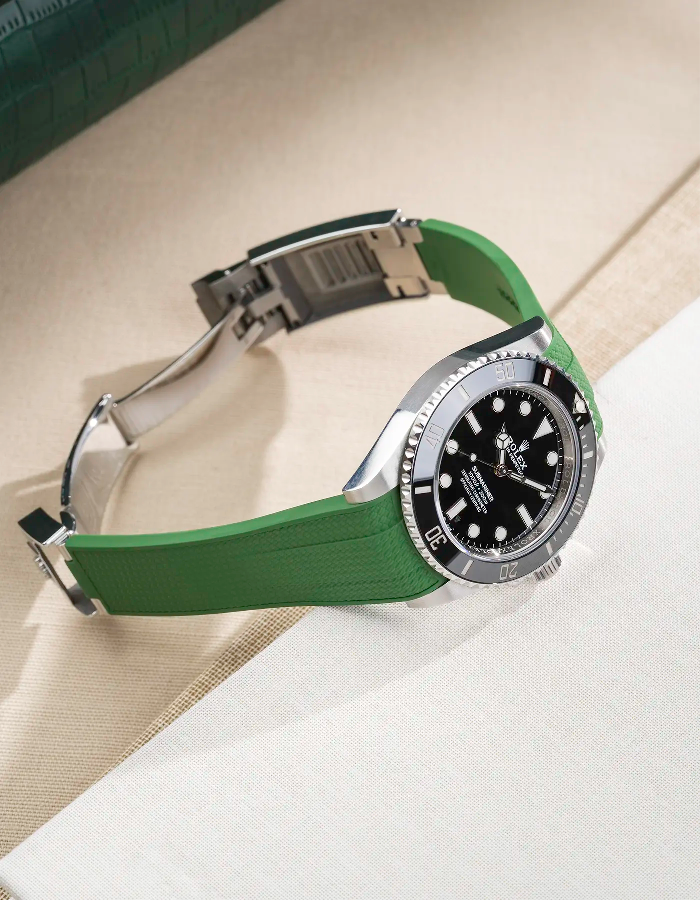 Side angle product photo of Rolex Submariner 41 fitted with green Vertech FKM Rubber Strap sitting on the watch, integrated with original clasp – clasp open