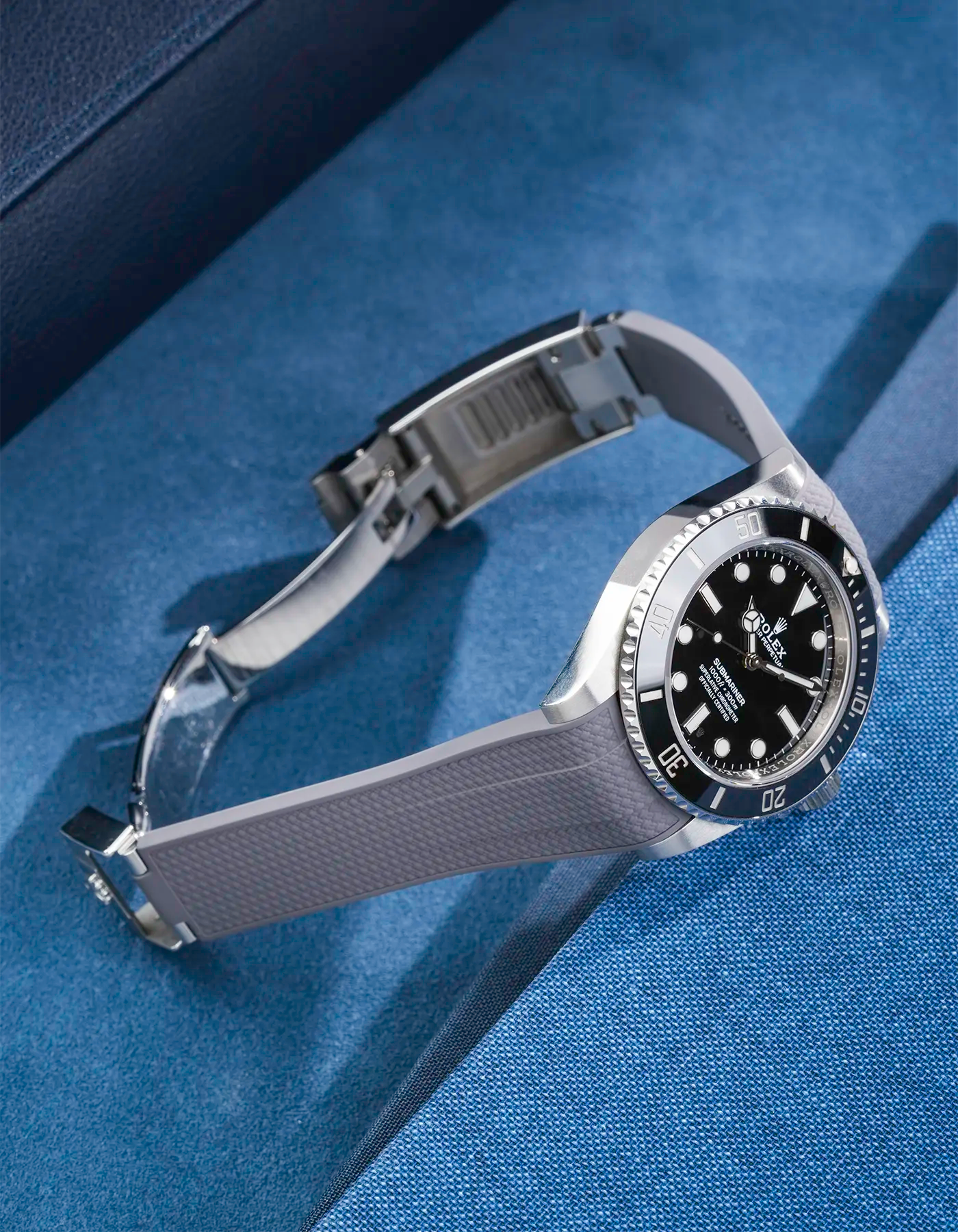 Product photo of Rolex Submariner 41 with grey Vertech FKM Rubber Strap mounted on the watch, integrated with original clasp – side angle view showing clasp open