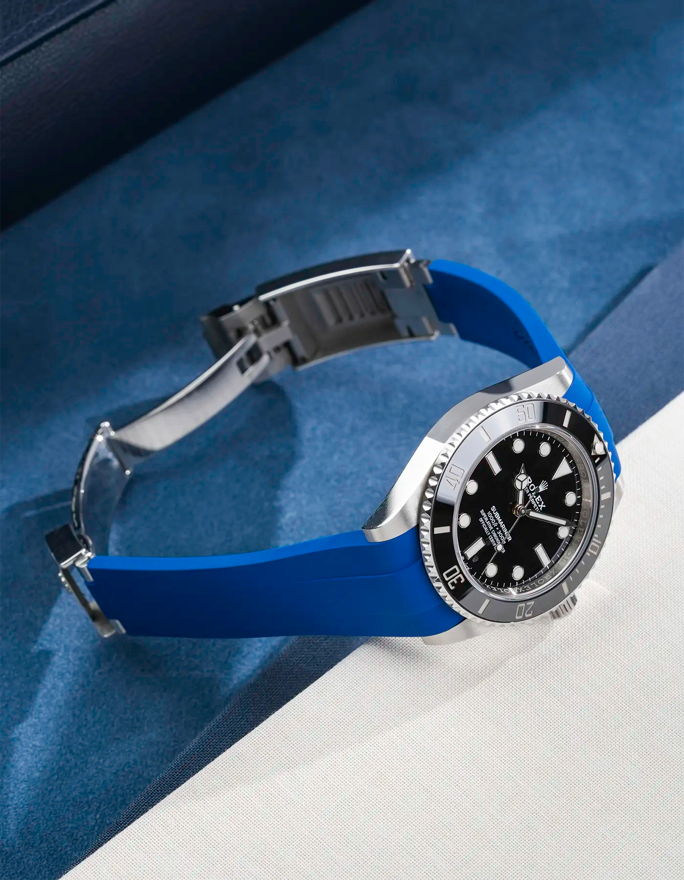Rolex Submariner 41 with navy blue Classic Smooth FKM Rubber Strap sitting on the watch, integrated with original clasp – product photo side angle with clasp open
