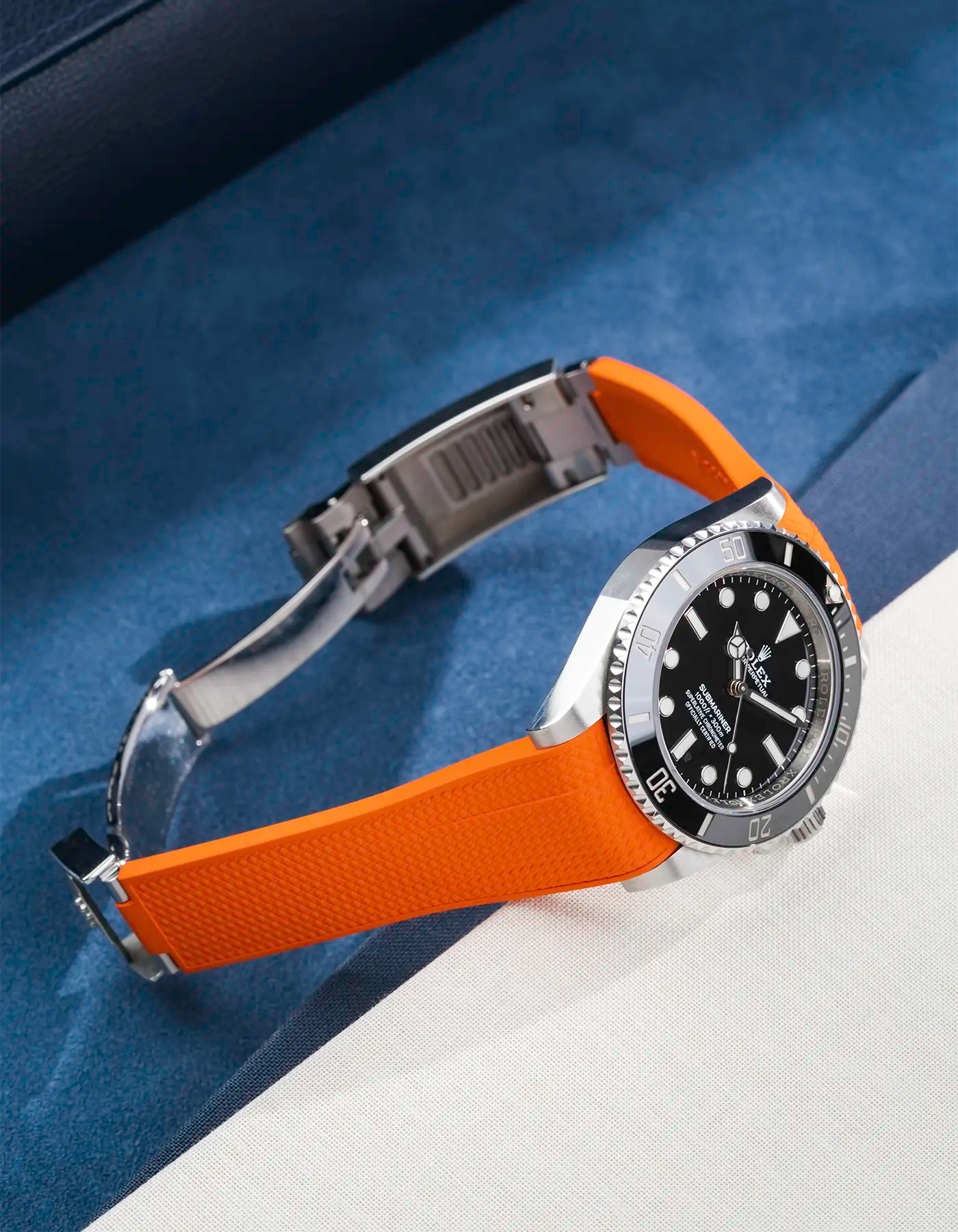 Product image of Rolex Submariner 41 with orange Vertech FKM Rubber Strap fitted on the watch, integrated with original clasp – side view showing clasp open