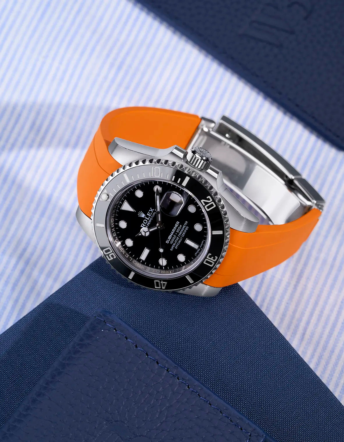 Rolex Submariner 116610LN with orange rubber strap integrated with original Rolex clasp – flat lay