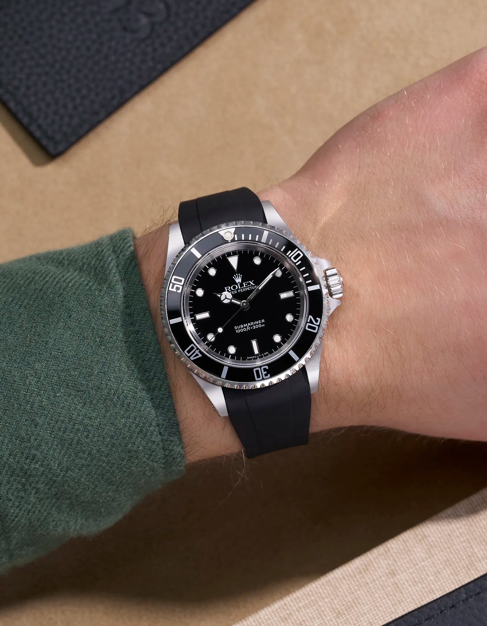 Wrist shot of Rolex Submariner 14060/16610 fitted with black curved FKM strap and original clasp – elegant fit and matte finish