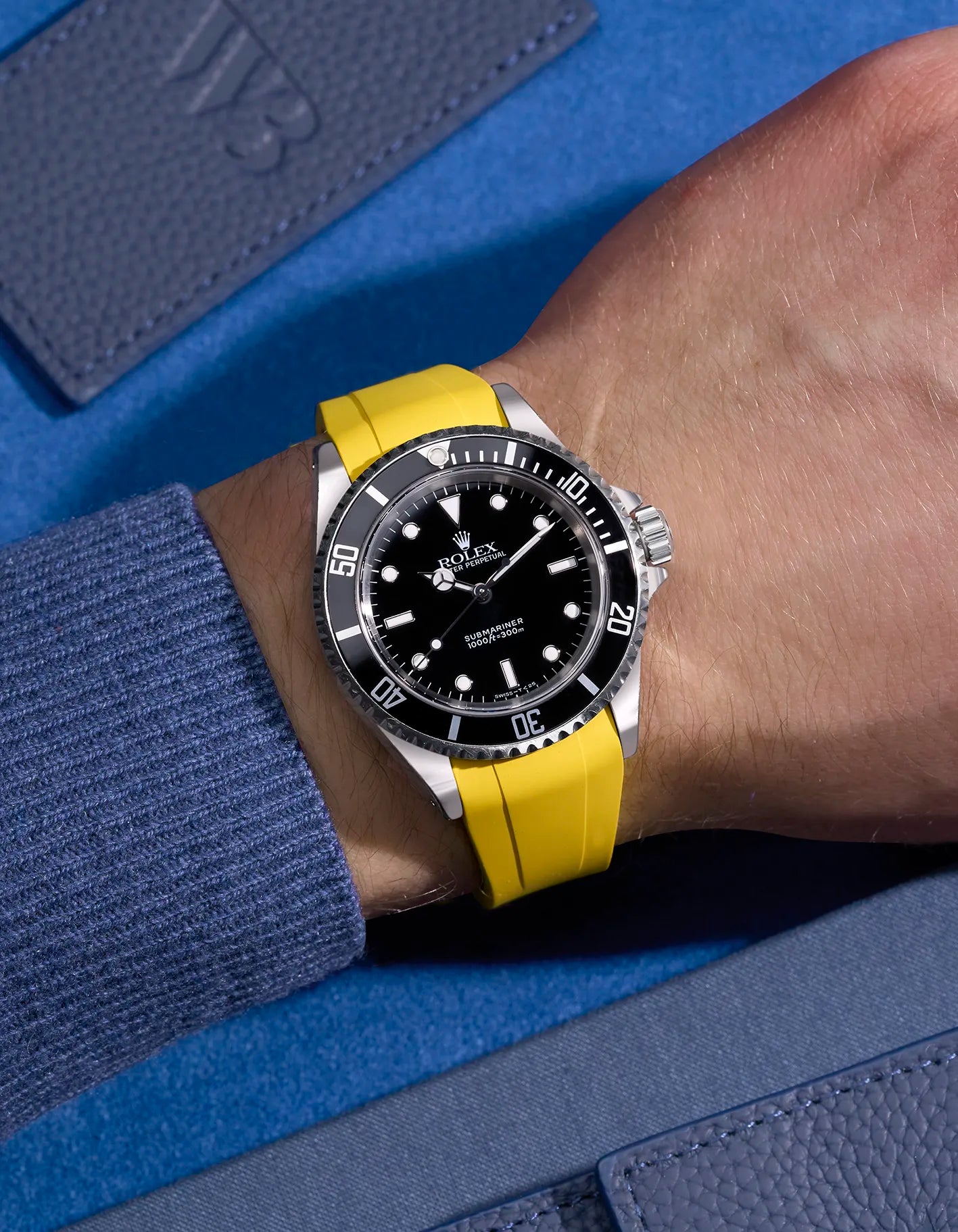 Rolex Submariner 16610 and 14060 on wrist with integrated yellow FKM rubber strap and original Rolex clasp