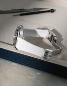 White Vertech FKM rubber strap for Rolex Submariner 116610 and 126610, integrated fit for original clasp, resting on a leather valet tray