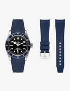 navy blue FKM tudor rubber watch strap with premium steel buckle on a light gray background with a Tudor BB41 watch in steel onthe side