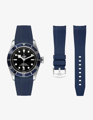 navy blue FKM tudor rubber watch strap with premium steel buckle on a light gray background with a Tudor BB41 watch in steel onthe side