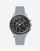 Black Omega Speedmaster watch with a dark grey vertech rubber watch strap from Wristbudyss and a detailed face on a white background