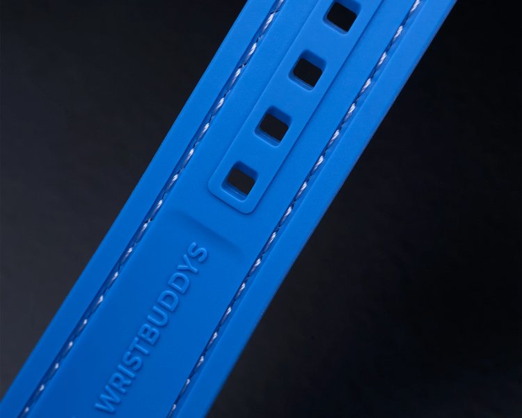 Blue Vertech Rubber Strap with reinforced sizing holes and WRISTBUDDYS logo – durability detail
