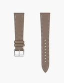 taupe leather watch strap from Wristbuddys in calfskin with a white background side by side with a steel buckle