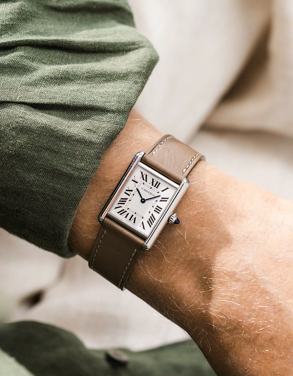 Cartier Tank Solo with a taupe calfskin leather watch strap from Wristbuddys on a wrist, wearing a green shirt.